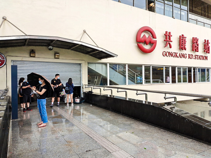 2021年7月26日,上海地铁一号线共康路站临时关闭,乘客在门口等待.